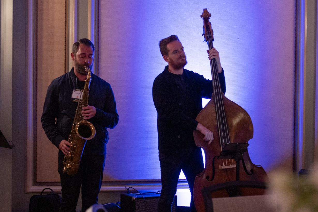 sax player performing next to an upright base player