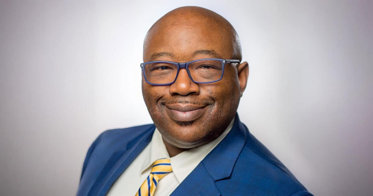 Bald black man in glasses and a blue suit, John Blackshear, University of Rochester vice president for student life.