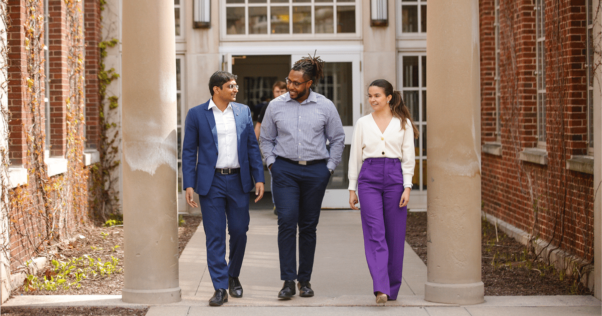 A group of students walk together on the University of Rochester campus.